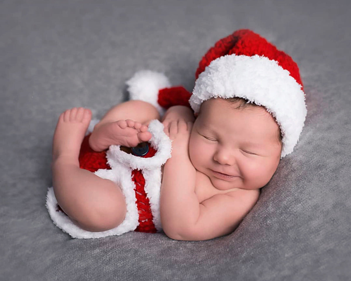 Soft red baby Santa hat with white fur trim