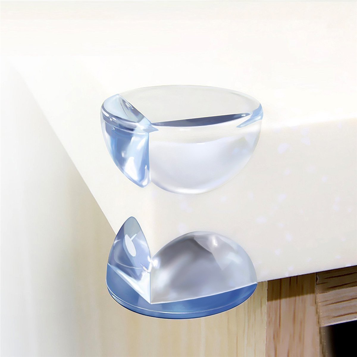 Clear silicone corner protector fitted on a table corner, top and bottom views