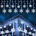 Snowflake LED curtain lights hanging in a window
