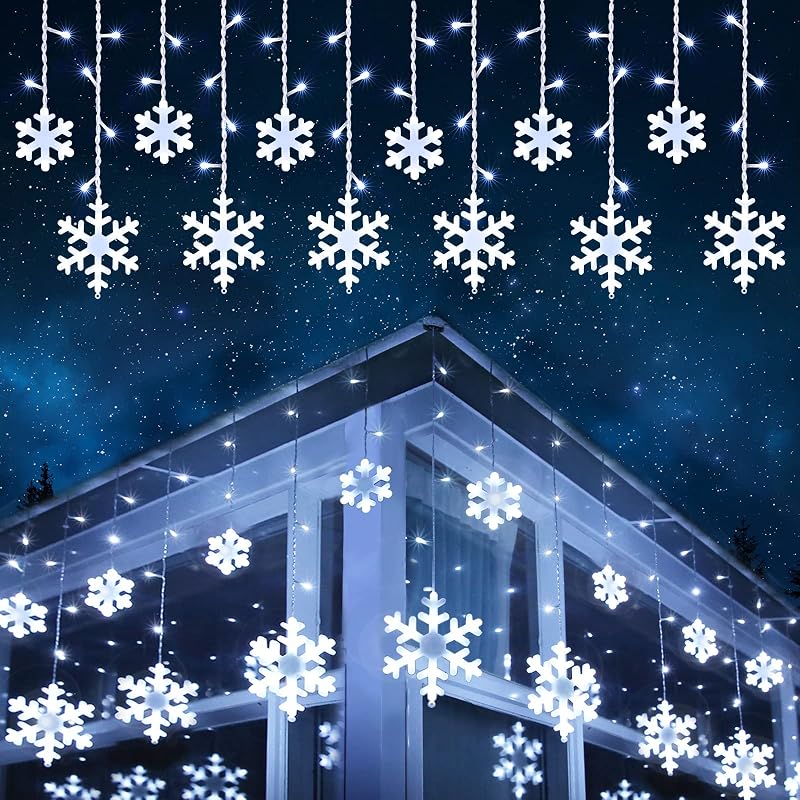 Snowflake LED curtain lights hanging in a window
