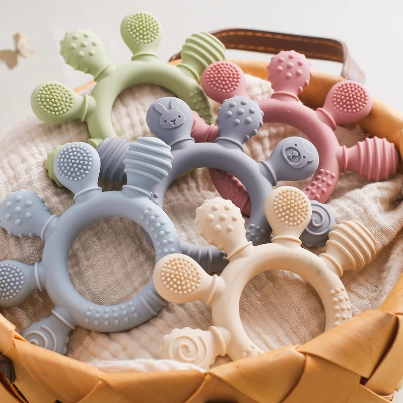 Silicone ring teethers in assorted soft colours