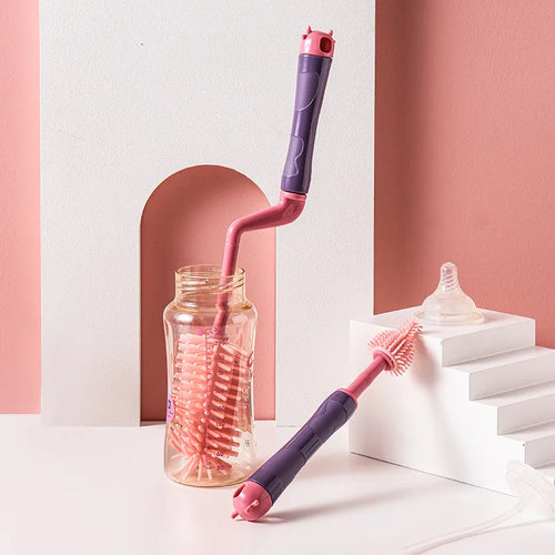 Silicone bottle brush with rotating handle cleaning a baby bottle, with nipple brush