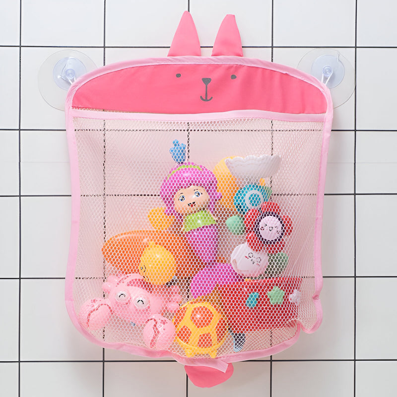 Pink bunny bath toy organizer mesh bag hanging on bathroom tiles with suction cups