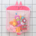 Pink bunny bath toy organizer mesh bag hanging on bathroom tiles with suction cups