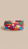 A front view shot of a chic headband featuring playful patterns, centered perfectly against a neutral, light-colored...