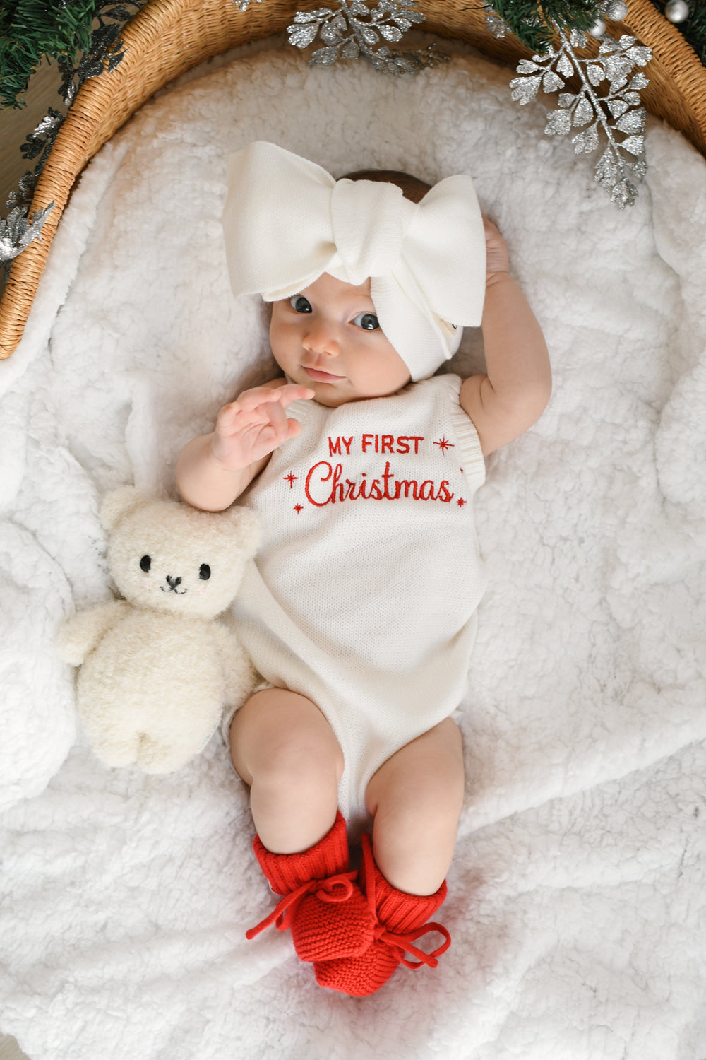 Baby wearing a knitted My First Christmas sweater romper